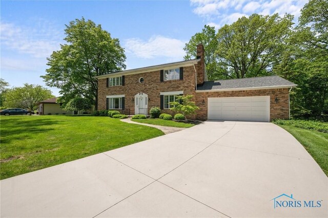 806 Woodstock Ct, Findlay, OH 45840 - colonial house featuring a garage, a front yard, a chimney, and driveway