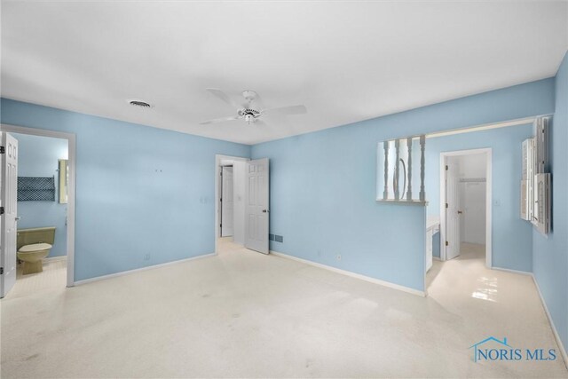 806 Woodstock Ct, Findlay, OH 45840 - unfurnished bedroom featuring a walk in closet, baseboards, carpet flooring, and a closet