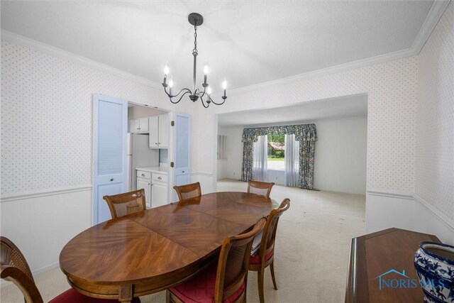 806 Woodstock Ct, Findlay, OH 45840 - dining space featuring crown molding, wallpapered walls, a chandelier, wainscoting, and light carpet