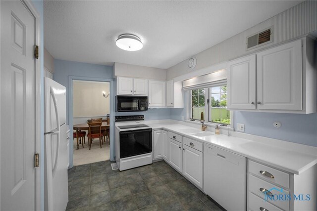 806 Woodstock Ct, Findlay, OH 45840 - kitchen featuring white appliances, a sink, white cabinets, and light countertops