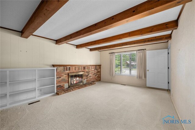 806 Woodstock Ct, Findlay, OH 45840 - unfurnished living room with beamed ceiling, carpet, and a brick fireplace