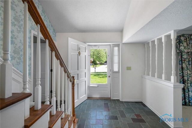 806 Woodstock Ct, Findlay, OH 45840 - entrance foyer featuring stairway, stone tile floors, a textured ceiling, and baseboards