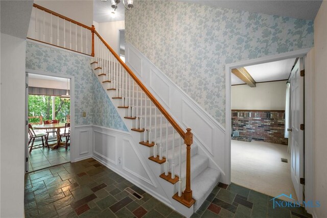 806 Woodstock Ct, Findlay, OH 45840 - stairs featuring wallpapered walls, a wainscoted wall, and stone finish flooring