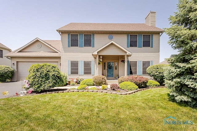 1424 S Redhawk Dr, Perrysburg, OH 43551 - view of front of home with a garage, a chimney, and a front lawn