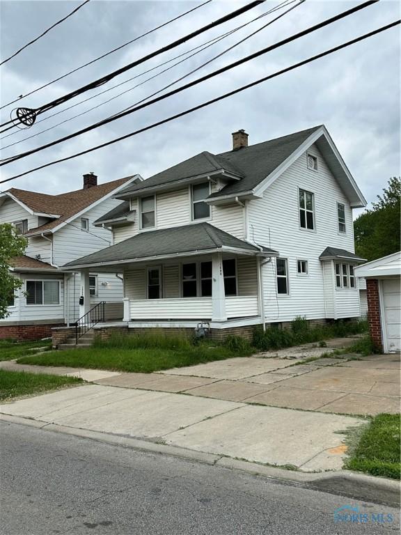 1448 Berdan Ave, Toledo, OH 43612 - view of front of home with covered porch, driveway, and a garage