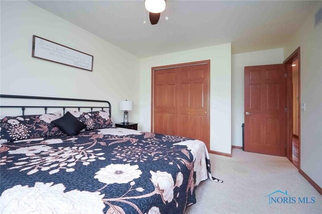 501 Flintlock Ct, Findlay, OH 45840 - bedroom with carpet, a closet, baseboards, and a ceiling fan