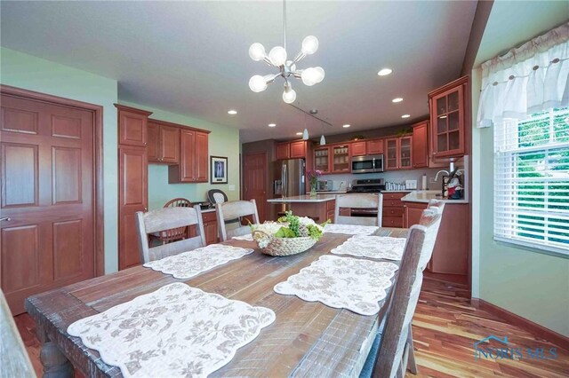 501 Flintlock Ct, Findlay, OH 45840 - dining area with a chandelier, light wood-type flooring, recessed lighting, and baseboards
