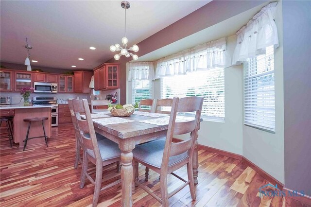 501 Flintlock Ct, Findlay, OH 45840 - dining area featuring light wood finished floors, baseboards, recessed lighting, and a chandelier