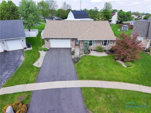 501 Flintlock Ct, Findlay, OH 45840 - view of front of property featuring stone siding, driveway, an attached garage, and roof with shingles