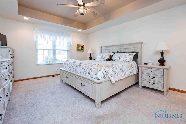 501 Flintlock Ct, Findlay, OH 45840 - bedroom with light colored carpet, recessed lighting, baseboards, ceiling fan, and a raised ceiling
