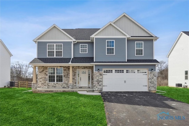 craftsman-style home featuring board and batten siding, a porch, driveway, central air condition unit, and stone siding