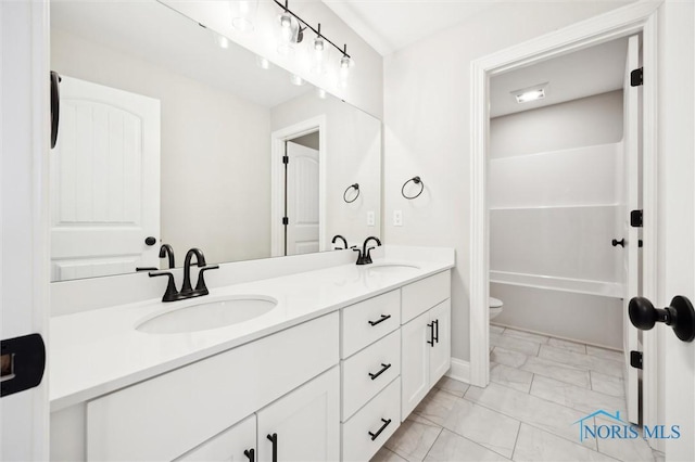 bathroom with marble look tile flooring, double vanity, toilet, a bath, and a shower