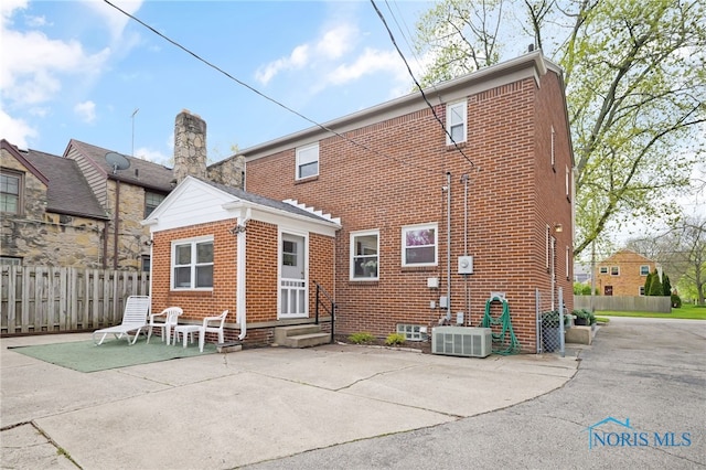 2324 Secor Rd, Toledo, OH 43606 - rear view of property with brick siding, a patio area, cooling unit, and entry steps