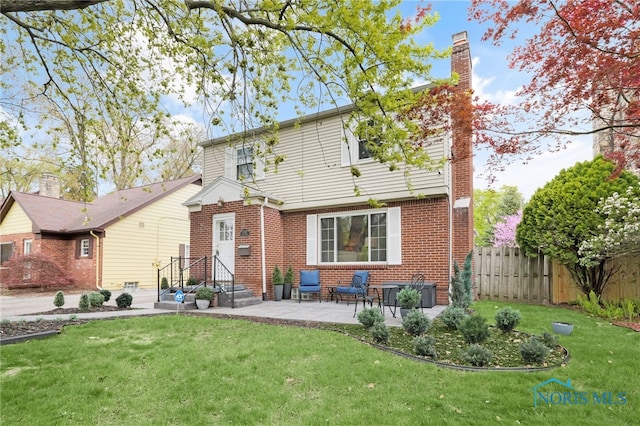 2324 Secor Rd, Toledo, OH 43606 - back of house with brick siding, a chimney, and a patio area