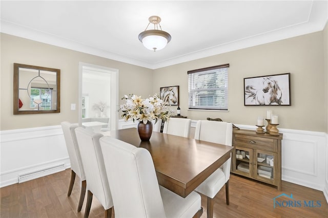 2324 Secor Rd, Toledo, OH 43606 - dining area with wainscoting, wood finished floors, and a decorative wall