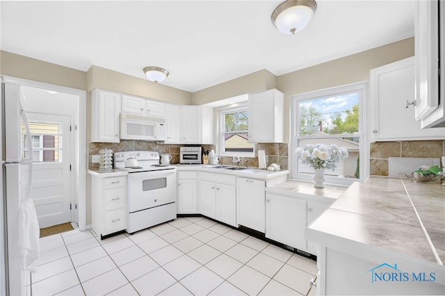 2324 Secor Rd, Toledo, OH 43606 - kitchen featuring white appliances, decorative backsplash, a sink, white cabinets, and light countertops