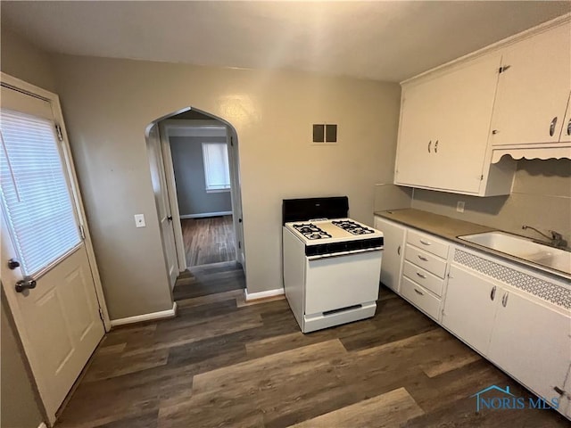 3333 Mulberry St, Toledo, OH 43608 - kitchen featuring gas range gas stove, arched walkways, white cabinetry, and dark wood-style floors