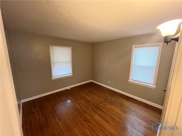3333 Mulberry St, Toledo, OH 43608 - empty room with dark wood-style flooring and baseboards