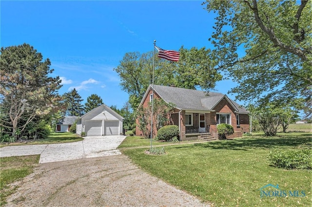 26331 Pemberville Rd, Perrysburg, OH 43551 - view of front of house featuring brick siding, a garage, a front yard, an outdoor structure, and driveway