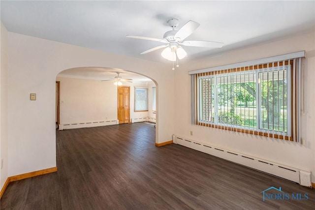 26331 Pemberville Rd, Perrysburg, OH 43551 - unfurnished room featuring a baseboard heating unit, arched walkways, a ceiling fan, and dark wood-style floors