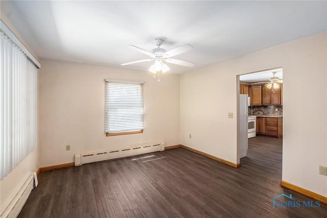 26331 Pemberville Rd, Perrysburg, OH 43551 - empty room with a baseboard heating unit, baseboard heating, ceiling fan, dark wood-style floors, and baseboards