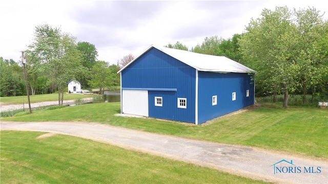 5412 Evansport Rd, Defiance, OH 43512 - view of pole building featuring a lawn and view of wooded area