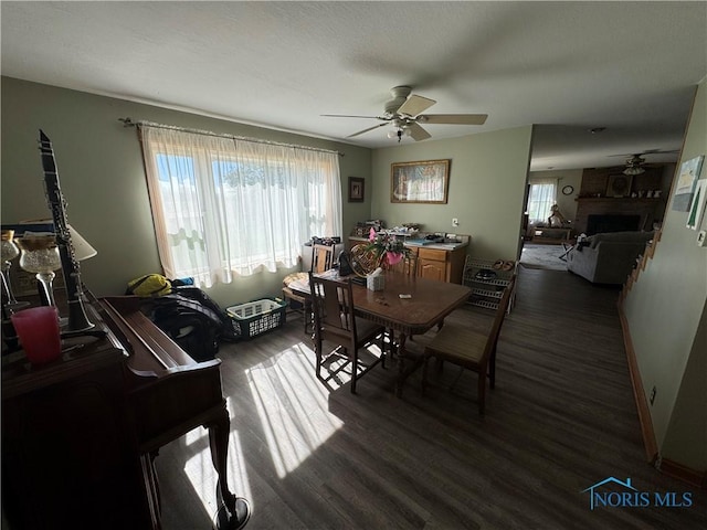 5412 Evansport Rd, Defiance, OH 43512 - dining area featuring a ceiling fan, wood finished floors, and a fireplace