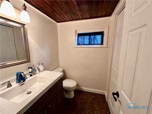 203 Washington St, Bettsville, OH 44815 - bathroom featuring wood ceiling, toilet, vanity, and baseboards