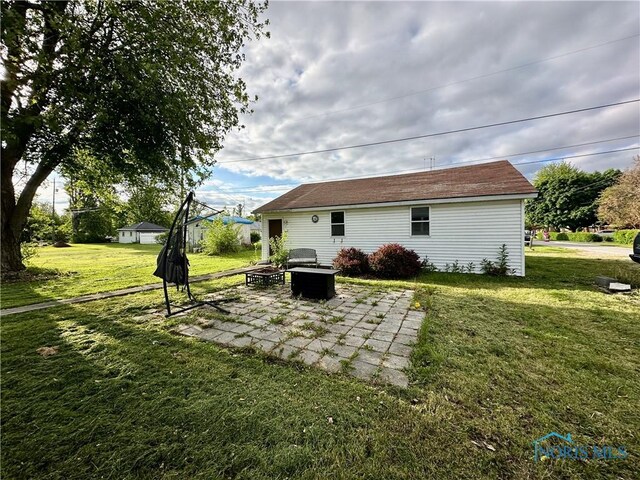 203 Washington St, Bettsville, OH 44815 - back of house featuring a patio, a yard, and an outdoor fire pit