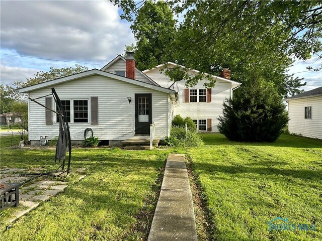 203 Washington St, Bettsville, OH 44815 - view of front of house with a front yard and a chimney