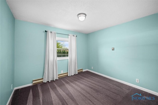 1473 State Route 66, Stryker, OH 43557 - unfurnished room with dark colored carpet, a textured ceiling, baseboards, and baseboard heating