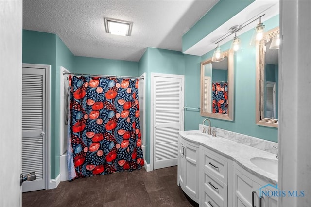 1473 State Route 66, Stryker, OH 43557 - bathroom featuring a closet, double vanity, a textured ceiling, curtained shower, and baseboards
