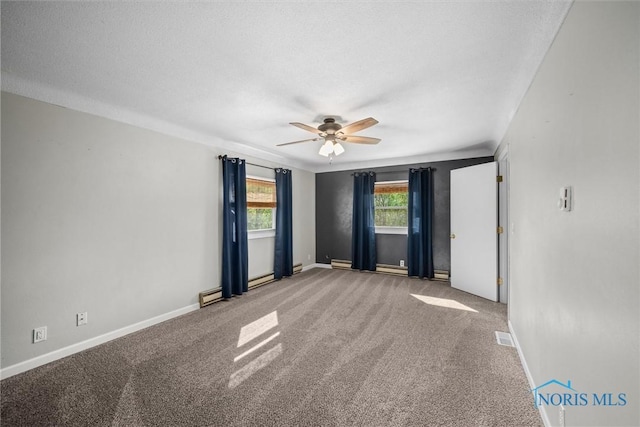 1473 State Route 66, Stryker, OH 43557 - carpeted spare room featuring a ceiling fan, baseboards, and a baseboard heating unit