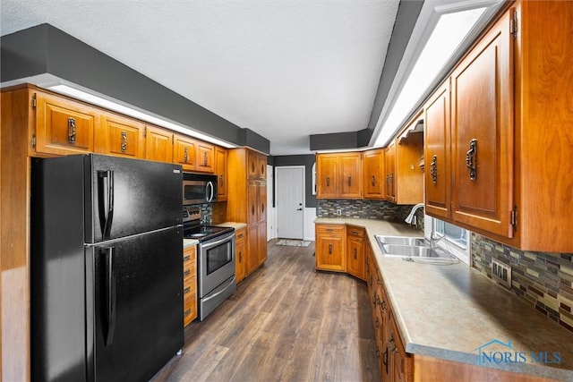 1473 State Route 66, Stryker, OH 43557 - kitchen featuring stainless steel appliances, a sink, and brown cabinetry
