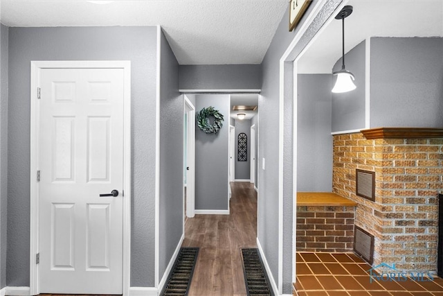 1473 State Route 66, Stryker, OH 43557 - corridor with dark wood-style flooring and a textured ceiling