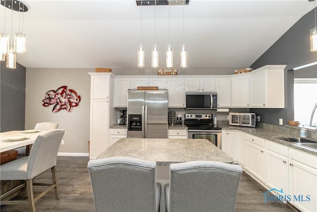 1474 Marsh Hawk Rd, Perrysburg, OH 43551 - kitchen featuring appliances with stainless steel finishes, a sink, white cabinetry, dark wood-style floors, and vaulted ceiling