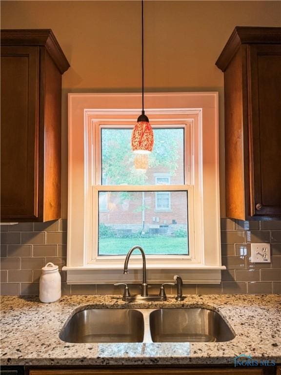 348 S 8th St, Upper Sandusky, OH 43351 - kitchen featuring tasteful backsplash, light stone countertops, and pendant lighting