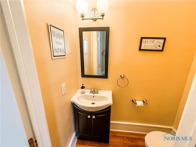 348 S 8th St, Upper Sandusky, OH 43351 - bathroom with vanity, wood finished floors, and a chandelier