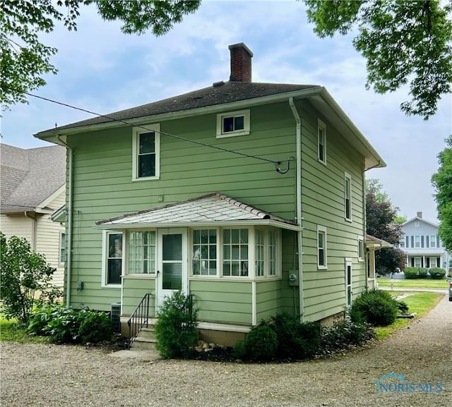 348 S 8th St, Upper Sandusky, OH 43351 - rear view of property featuring a chimney and entry steps