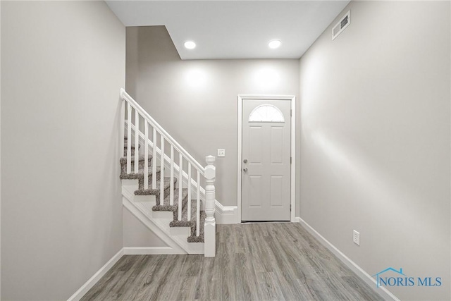 145 E Crocker St, Fostoria, OH 44830 - entrance foyer featuring baseboards, wood finished floors, and stairs