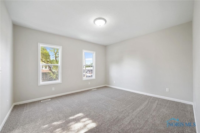 145 E Crocker St, Fostoria, OH 44830 - carpeted empty room with baseboards