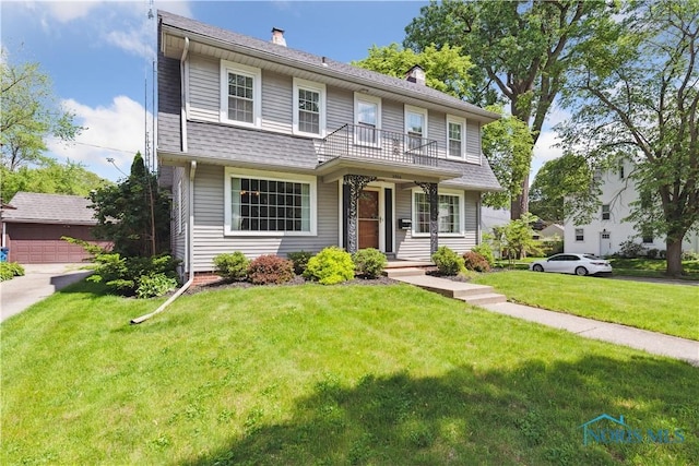 2904 Goddard Rd, Toledo, OH 43606 - view of front of home featuring a chimney, a front yard, and a balcony