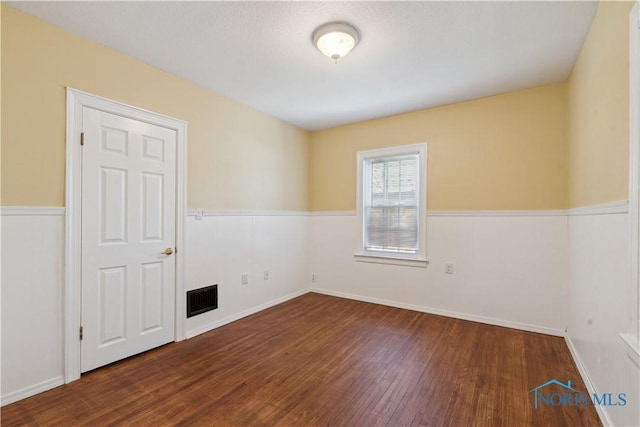 2904 Goddard Rd, Toledo, OH 43606 - spare room featuring wood finished floors and a wainscoted wall