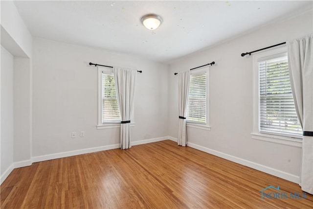 2904 Goddard Rd, Toledo, OH 43606 - unfurnished room with light wood finished floors, plenty of natural light, and baseboards