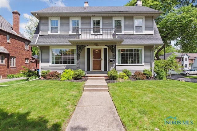 2904 Goddard Rd, Toledo, OH 43606 - view of front of property with a front lawn, a chimney, and a shingled roof