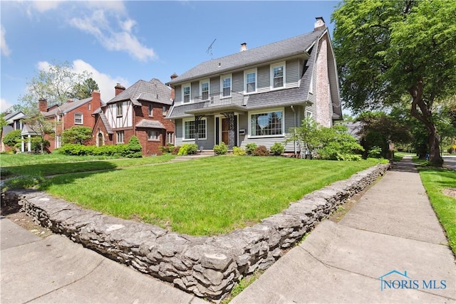 2904 Goddard Rd, Toledo, OH 43606 - view of front facade with a front yard, a chimney, and covered porch