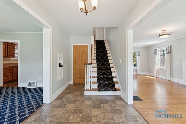 2904 Goddard Rd, Toledo, OH 43606 - entrance foyer with stairway, a chandelier, and baseboards