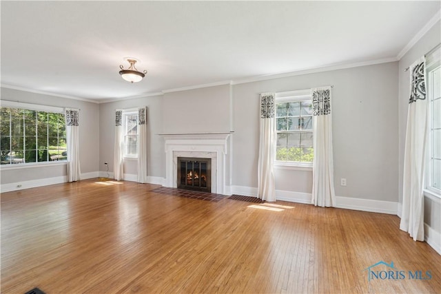 2904 Goddard Rd, Toledo, OH 43606 - unfurnished living room with light wood-style floors, plenty of natural light, a premium fireplace, baseboards, and crown molding