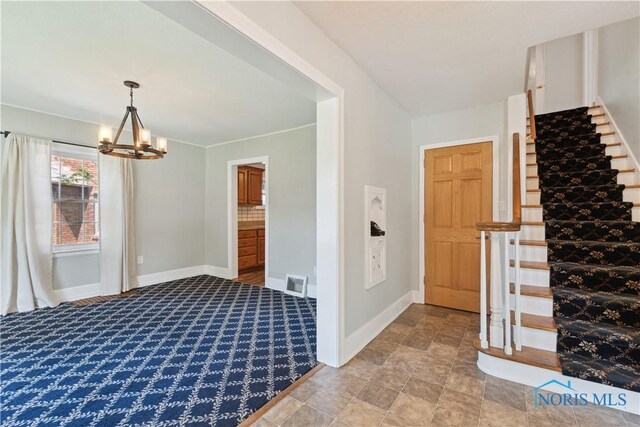 2904 Goddard Rd, Toledo, OH 43606 - foyer entrance featuring a chandelier, baseboards, stairway, and light colored carpet