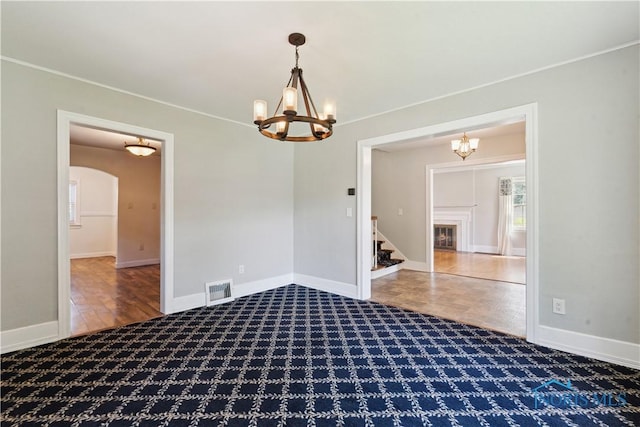 2904 Goddard Rd, Toledo, OH 43606 - empty room with a chandelier, carpet, stairway, baseboards, and ornamental molding